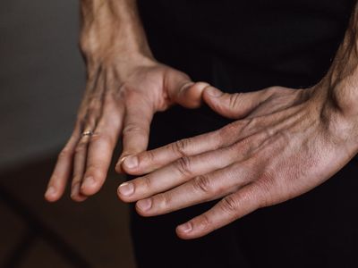 Close-up on hands in a specific yoga mudra.