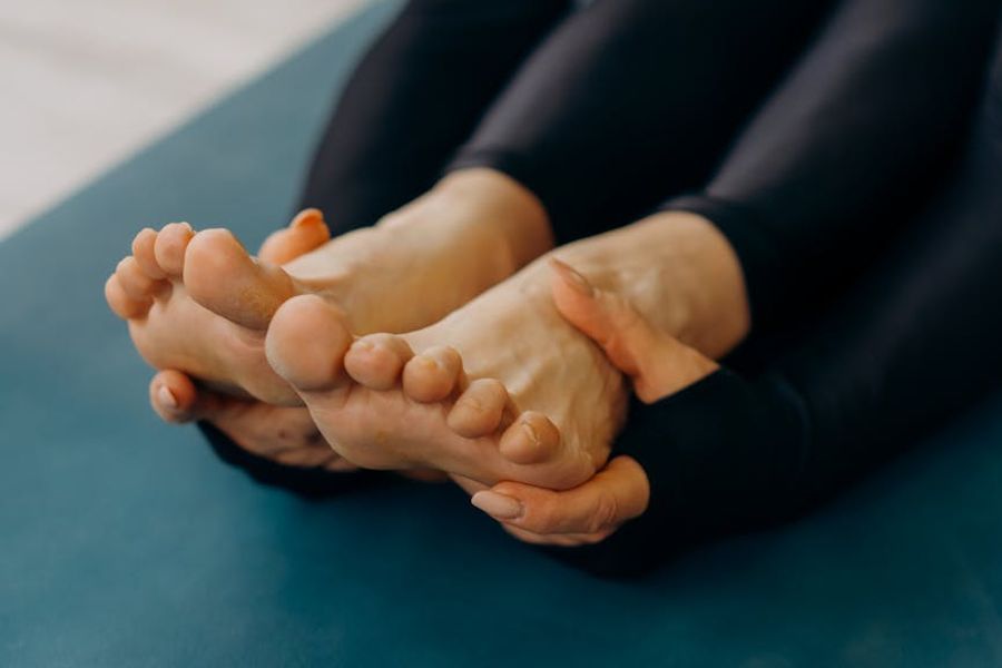 Person holding a difficult balancing yoga pose.